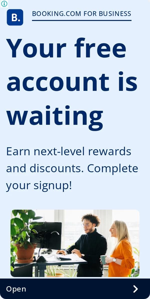 A Booking.com for Business 300 by 600 display ad with the headline Your free account is waiting, a description about rewards and discounts and completing your signup, a photo of two people at a desk, and an Open button