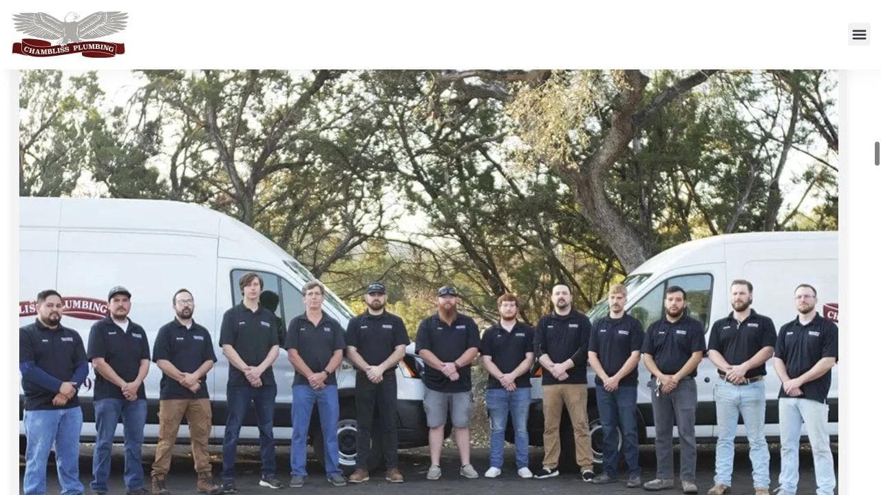 Chambliss Plumbing local team standing in front of service vans