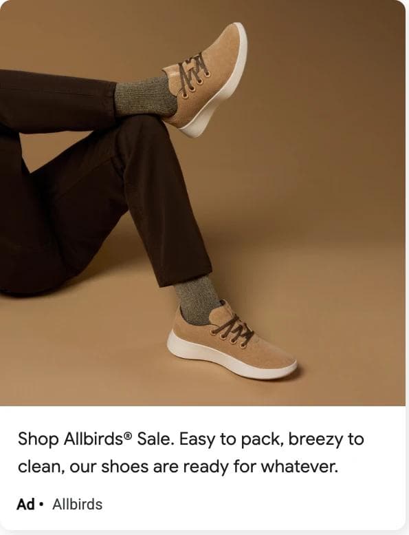 An Allbirds display ad: a photo of crossed legs in brown trousers and tan sneakers on a tan background, under the description Shop Allbirds Sale, easy to pack, breezy to clean, our shoes are ready for whatever